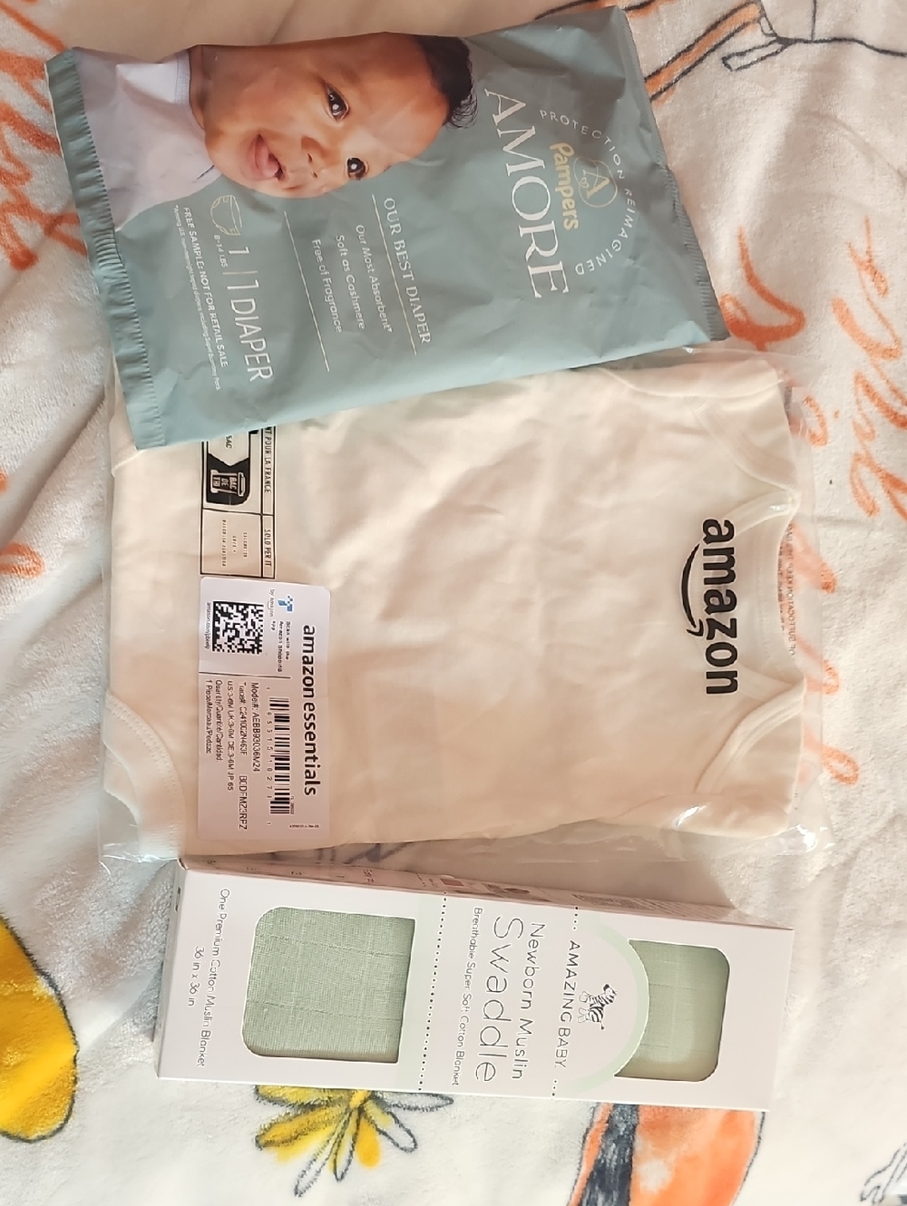 Amazon Neutral Cream Baby Onesie with Mint Muslin Swaddle and Teal Diaper Pack